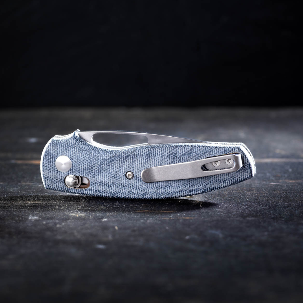 TRM Bulldog Rev B closed knife on a wood table with dark background